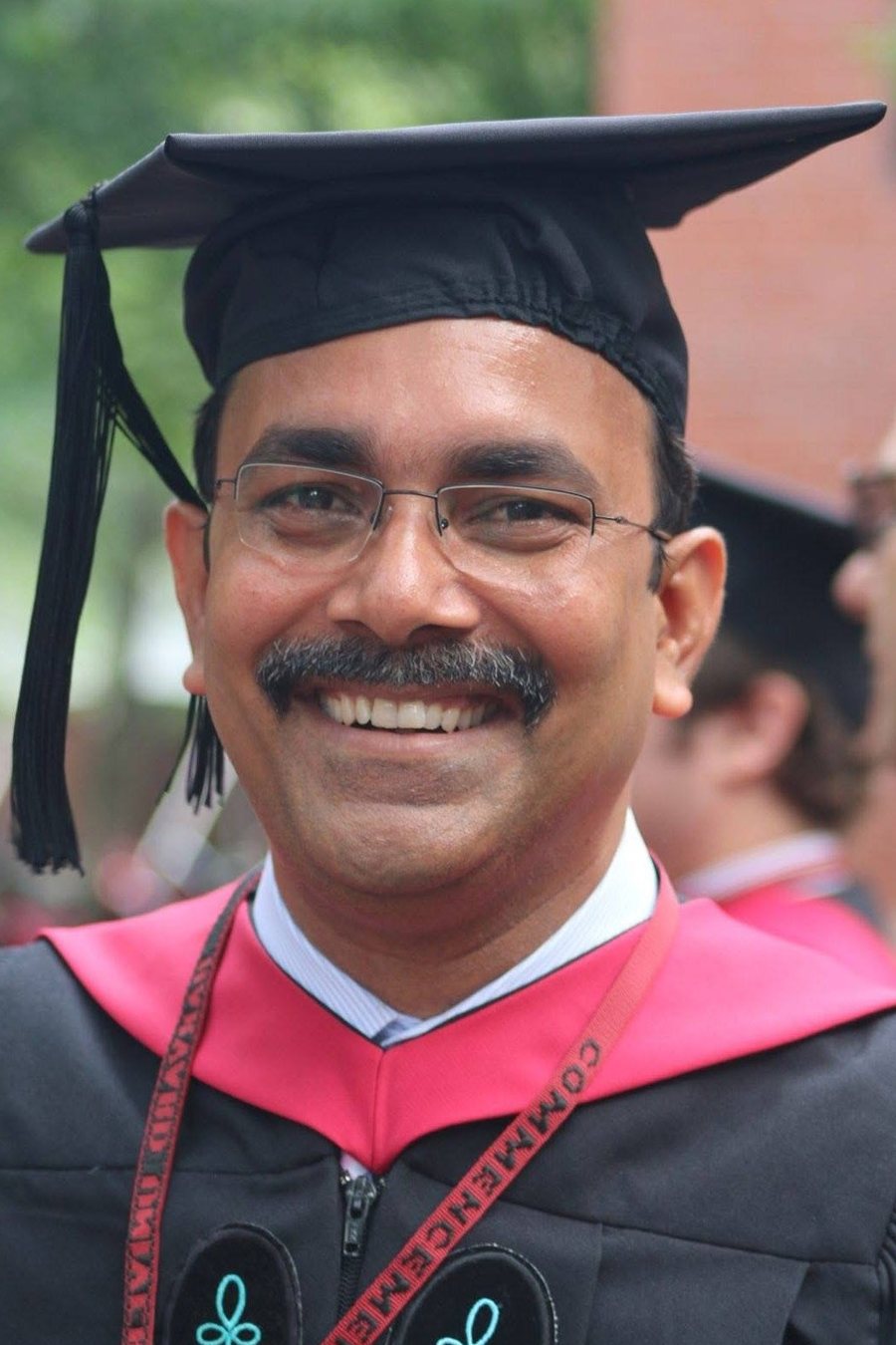 Dr. Sanjay Kumar in cap and gown at Harvard commencement